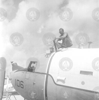 Man sitting on top of R4D aircraft