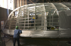 Shipyard workers assembling hull frame of R/V Tioga.