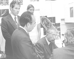 Scientists looking on with Emperor Hirohito.
