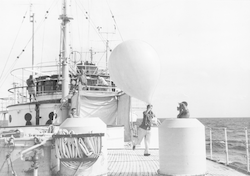 Man with a weather balloon on deck of Anton Bruun