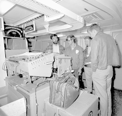 Group working with equipment below deck