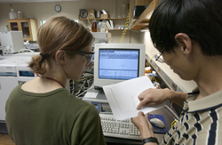 Emma Teuten and Li Xu working in the NOSAMS facility.