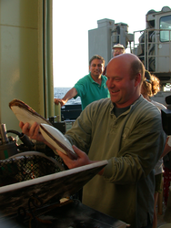 Tim Shank holding two large clams recovered with Alvin.