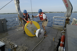 Postdoctoral scholar Dave Ralston and Jay Sisson with a recovered mooring.