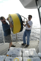 Dave Ralston and Jim Lerczak carry a mooring to the bow.