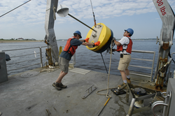 Postdoc Dave Ralston and Jay Sisson recover a mooring bouy.