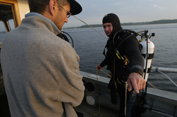 Rocky Geyer chats with diver Jay Sisson after locating a lost tripod.