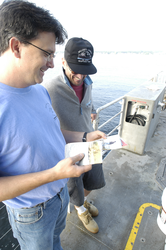Jim Lerczak and Rocky Geyer review pictures on the aft deck