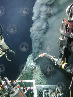Manipulator probe sampling black smoker chimney fluids during Alvin dive 3749.