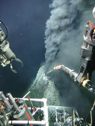 Manipulator probe sampling black smoker chimney fluids during Alvin dive 3749.