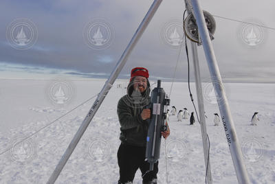 Mak Saito holding a water sample from under the ice.