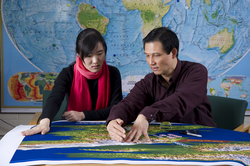 Jian Lin and his guest student, Tingting Wang, reviewing earthquake charts.