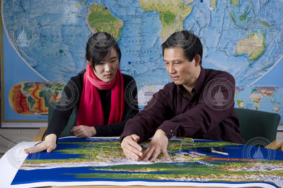 Jian Lin and his guest student, Tingting Wang, reviewing earthquake charts.