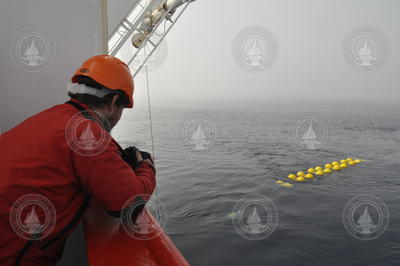 Ben Harden waiting to take a photo of a mooring line diving off the surface.
