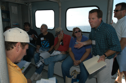 Jim Edson (green shirt) talking to the tour group during the transit to MVCO.