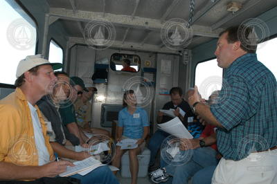 Jim Edson (green shirt) talking to the tour group during the transit to MVCO.