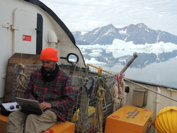 Ari Daniel working on assignment in Sermilik Fjord, Greenland.