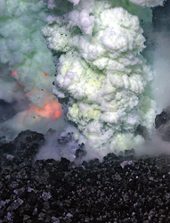 West Mata volcano spewing red-hot magma and a plume of sulfurous fluid.