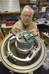 Victor Bender working on an ocean bottom seismometer.