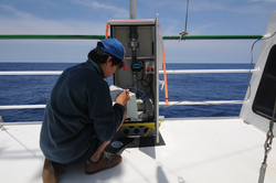 Hiroomi Miyamoto checks on an aerosol sampler on board R/V Ka'imikai-O-Kanaloa.