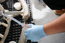 Water sample being extracted on deck from a sampling rosette.