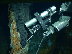 An IGT sampling a black smoker chimney at a hydrothermal vent field.