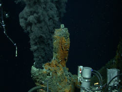 A billowing black smoker chimney at a hydrothermal vent field.