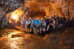 Geodynamics Program group photo in a volcano tunnel in Hawaii.