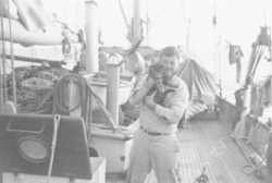 Don Fay holds ship's cat on Atlantis