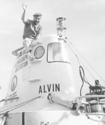 DSV Alvin pilot Val Wilson perched on top of the sub.