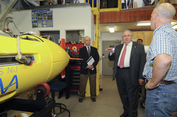 House speaker DeLeo talking with Mike Purcell about REMUS vehicles.