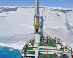 South African icebreaker SA Aghulhas II at an Antarctic ice shelf face.