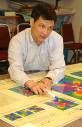 Jian Lin looking at a map.