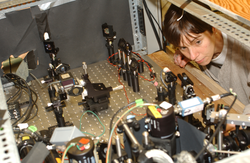 Heidi Sosik looking at the inside of the flow cytobot.