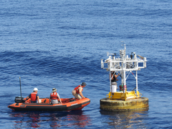 Mooring Techs troubleshoot instruments on buoy as part of SPURS-2.