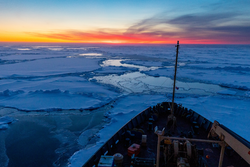 Sunrise beyond the Canadian icebreaker Louis S. St. Laurent near Beaufort Gyre.
