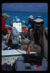 Scientist and crew on boat preparing a REMUS deployment.