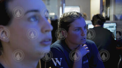 Casey Machado and Molly Curran watching NUI activities from the ship's control room.