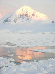 Antarctic peak reflected into waters below.