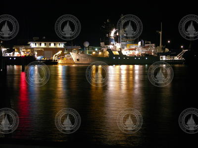 R/V Oceanus, R/V Endeavor and the R/V Knorr at the WHOI dock at night.