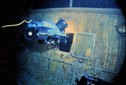 ROV Jason Jr. surveys through hull window into stateroom U. at RMS Titanic wreck site.