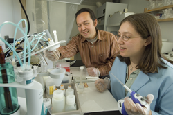 Mak Saito and Erin Bertrand working in lab.
