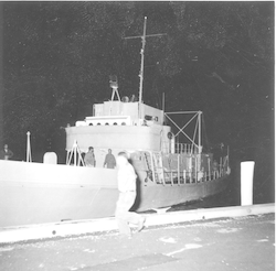 Unidentified men with Crawford at WHOI dock at night.