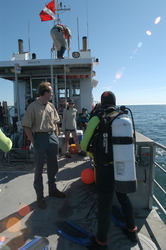 Ken Houtler on deck of Tioga with diver and 2004 Ocean Science Journalism Fellows.