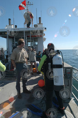 Ken Houtler on deck of Tioga with diver and 2004 Ocean Science Journalism Fellows.