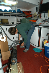 Heidi Sosik works on the power supply for the flow cytometer.